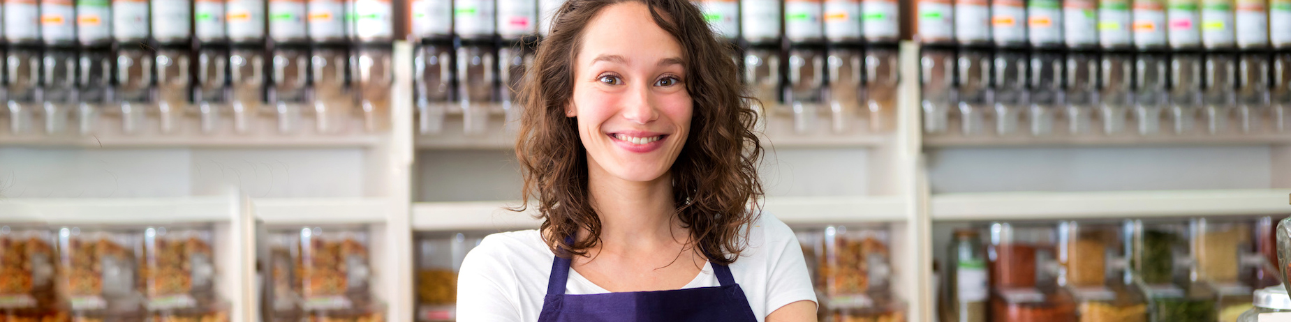 Young attractive woman working at the grocery store